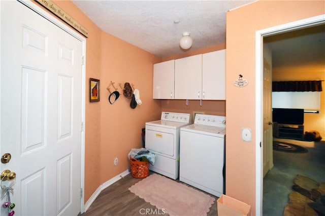 laundry area with baseboards, cabinet space, dark wood-style flooring, a textured ceiling, and washer and clothes dryer