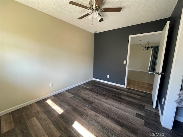 unfurnished bedroom with dark wood-type flooring, ceiling fan, and a textured ceiling