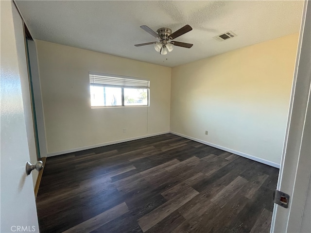 spare room featuring ceiling fan, a textured ceiling, and dark hardwood / wood-style flooring