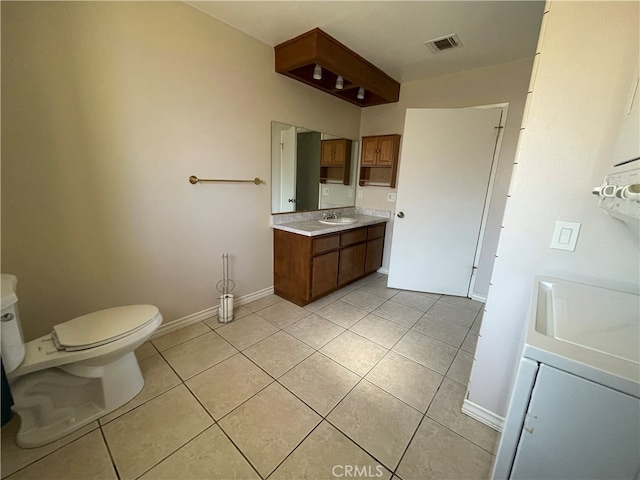 bathroom with vanity, toilet, and tile patterned flooring