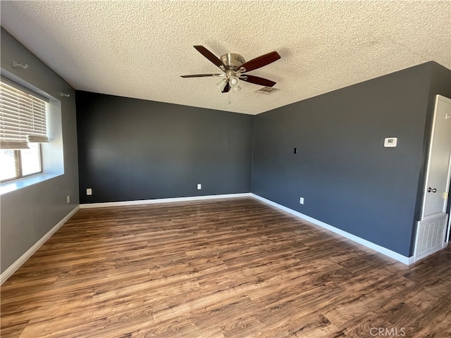 spare room with ceiling fan, hardwood / wood-style flooring, and a textured ceiling