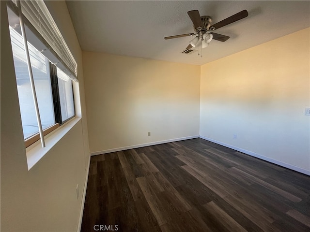 spare room featuring ceiling fan and dark hardwood / wood-style flooring