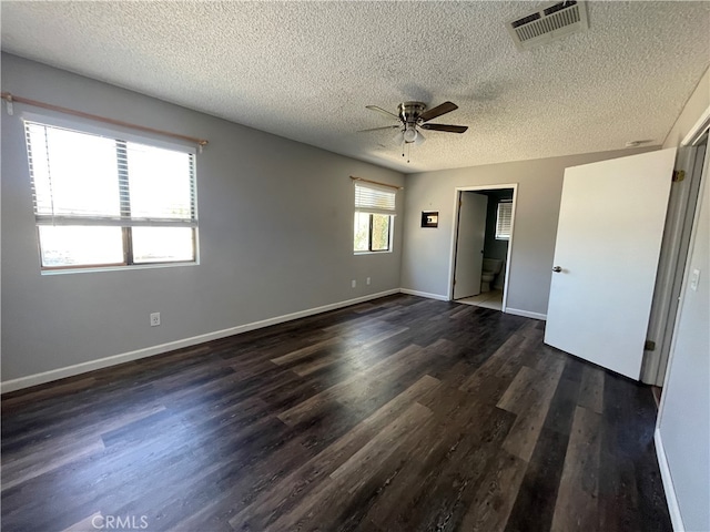 unfurnished bedroom featuring a textured ceiling, ceiling fan, and dark hardwood / wood-style flooring