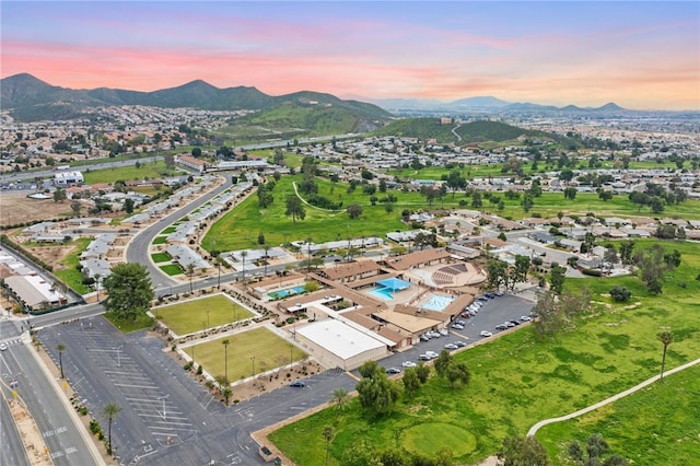 aerial view at dusk featuring a mountain view