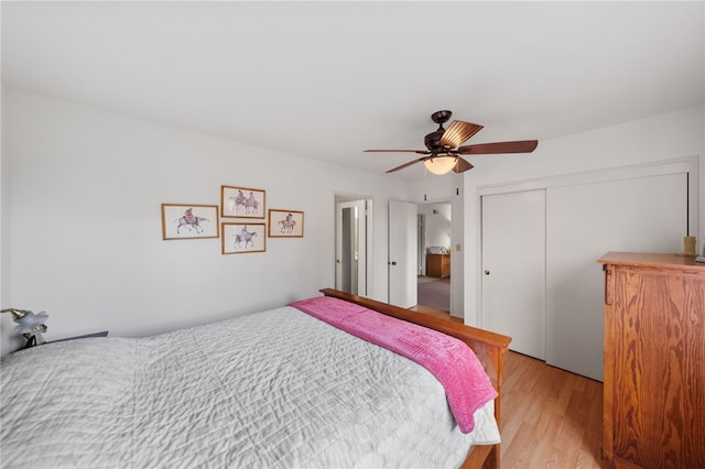 bedroom with ceiling fan, light hardwood / wood-style flooring, and a closet