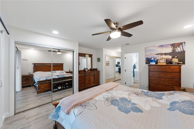 bedroom featuring light hardwood / wood-style flooring, a closet, and ceiling fan