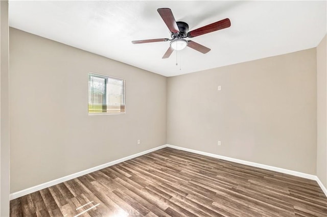 empty room with hardwood / wood-style floors and ceiling fan