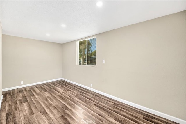 unfurnished room featuring wood-type flooring