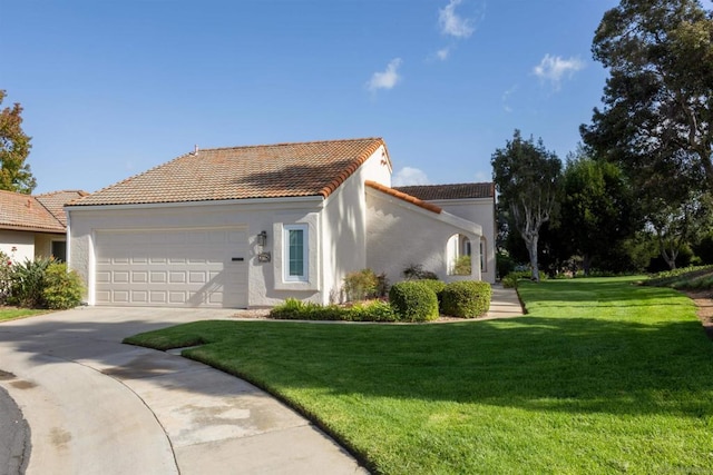 mediterranean / spanish house with a front yard and a garage