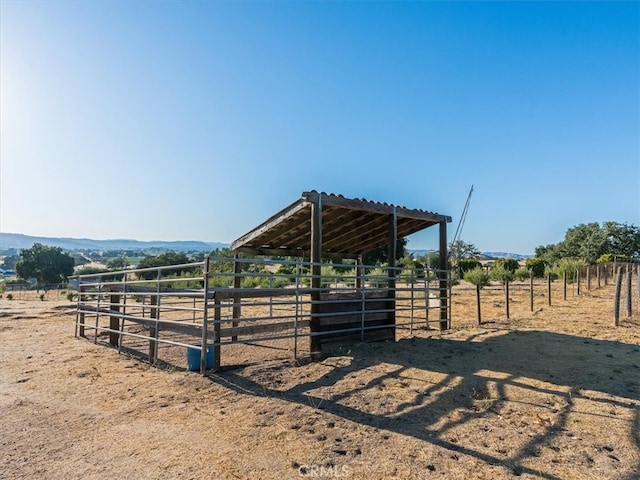 view of horse barn featuring a rural view