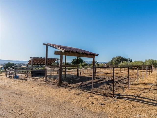 view of horse barn with a rural view