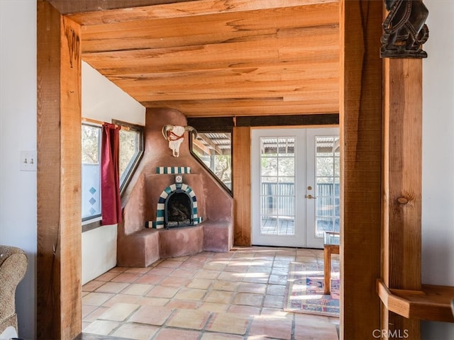 entryway with french doors, wood ceiling, plenty of natural light, and vaulted ceiling