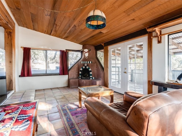 living room featuring french doors, wood ceiling, vaulted ceiling, and a healthy amount of sunlight