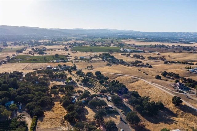 birds eye view of property featuring a mountain view and a rural view