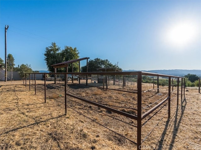 exterior space featuring an outdoor structure and a rural view