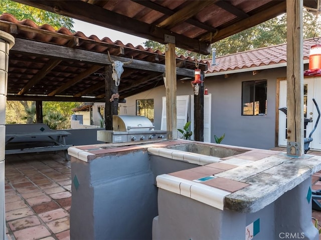 view of patio featuring area for grilling and exterior kitchen