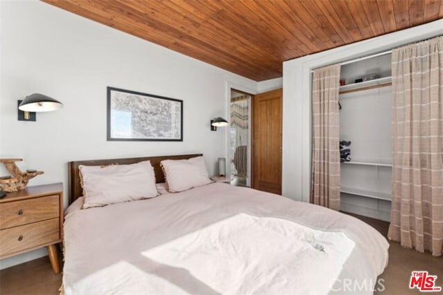 bedroom featuring carpet floors, wood ceiling, and a closet