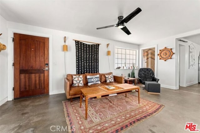 living room with concrete floors and ceiling fan