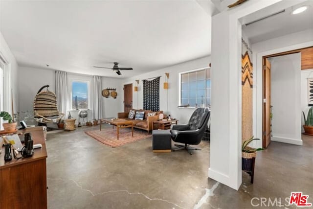 living room featuring concrete floors and ceiling fan