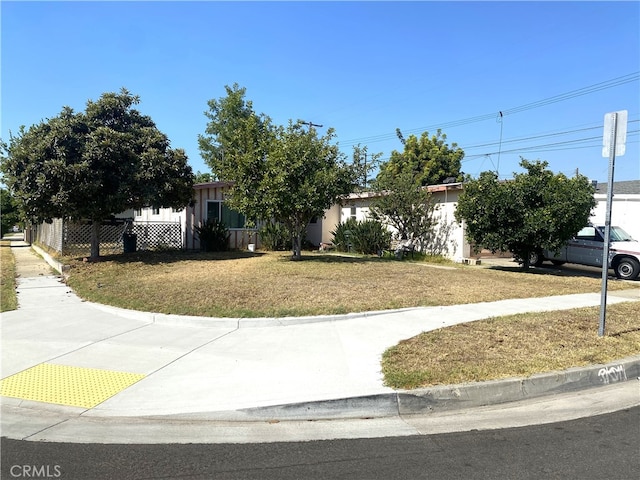 obstructed view of property featuring a front lawn