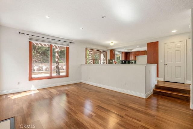 unfurnished living room with hardwood / wood-style floors