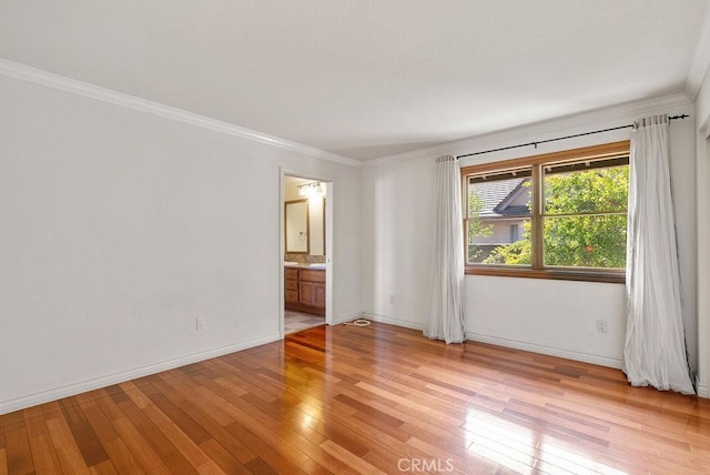 unfurnished room featuring light wood-type flooring and crown molding