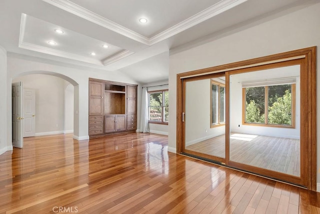 unfurnished living room with light wood-type flooring and ornamental molding