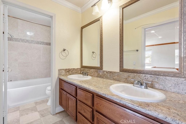 full bathroom with vanity, toilet, ornamental molding, and tiled shower / bath combo