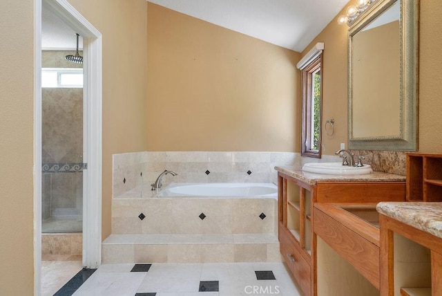 bathroom with vanity, vaulted ceiling, and shower with separate bathtub