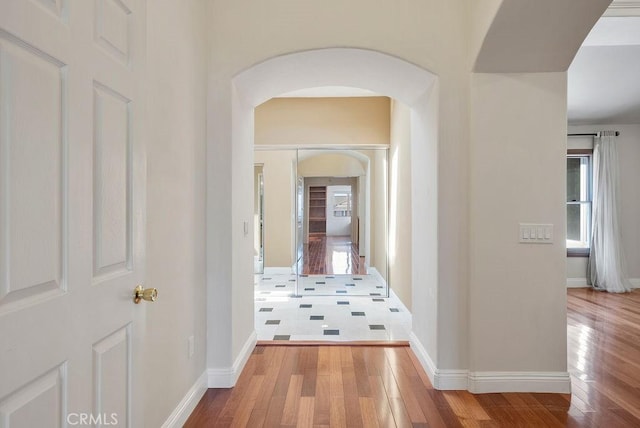 hallway with hardwood / wood-style flooring