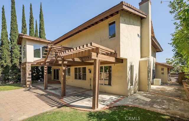 back of house featuring a pergola, central AC unit, and a patio area