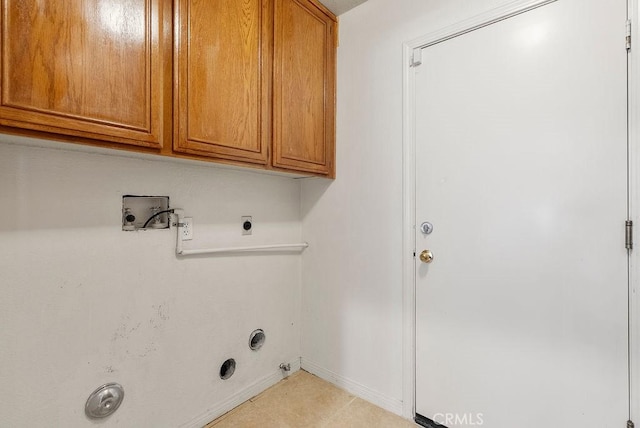 laundry room with washer hookup, hookup for an electric dryer, gas dryer hookup, and cabinets