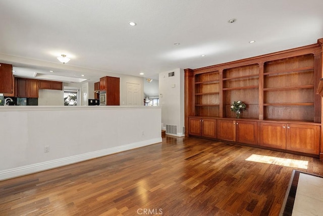 unfurnished living room with dark hardwood / wood-style flooring