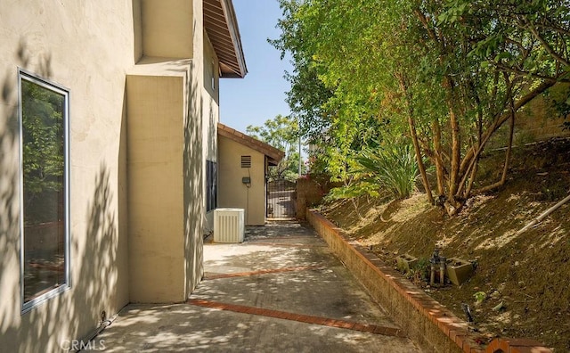 view of property exterior featuring a patio area and central AC