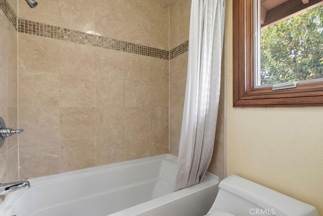 bathroom featuring toilet and shower / bath combo with shower curtain