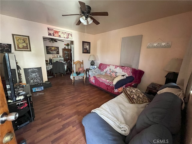 living room featuring ceiling fan and dark hardwood / wood-style flooring