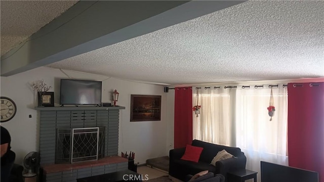 living room featuring a fireplace and a textured ceiling