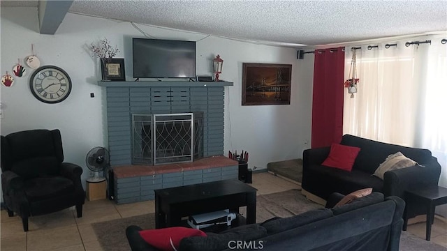 tiled living room featuring a textured ceiling and a brick fireplace