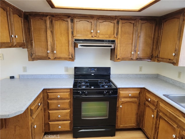 kitchen featuring light hardwood / wood-style flooring and black gas range oven