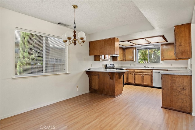 kitchen featuring dishwasher, kitchen peninsula, black range with electric cooktop, pendant lighting, and light hardwood / wood-style floors