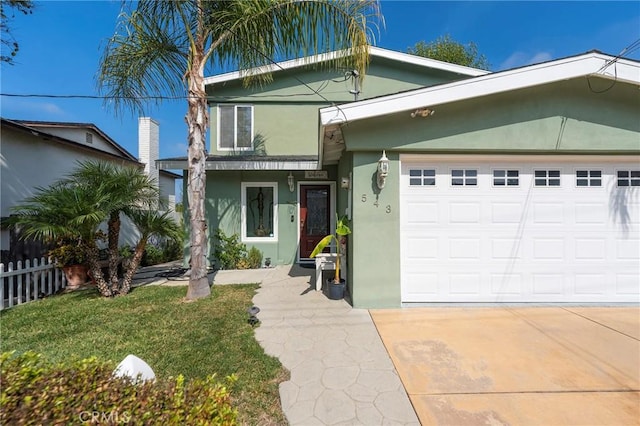 view of front of property featuring a garage and a front lawn