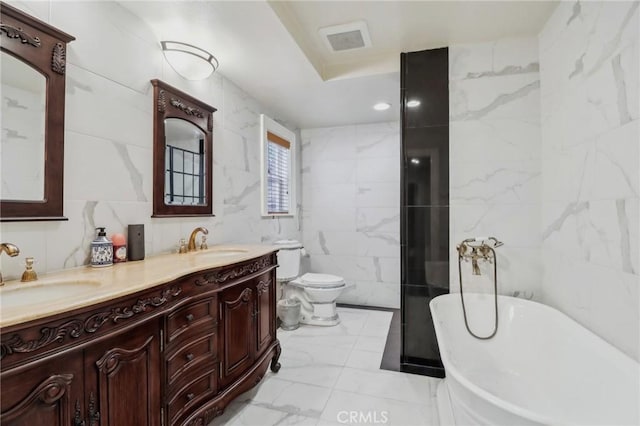 2611 Steeplechase Ln, Diamond Bar, CA 91765 - bathroom featuring tile walls, marble look tiles, a freestanding bath, toilet, and double vanity