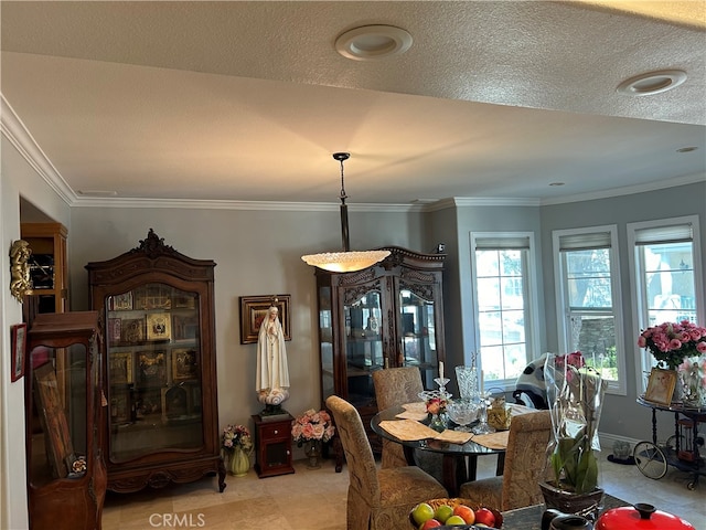 dining space with ornamental molding and a textured ceiling