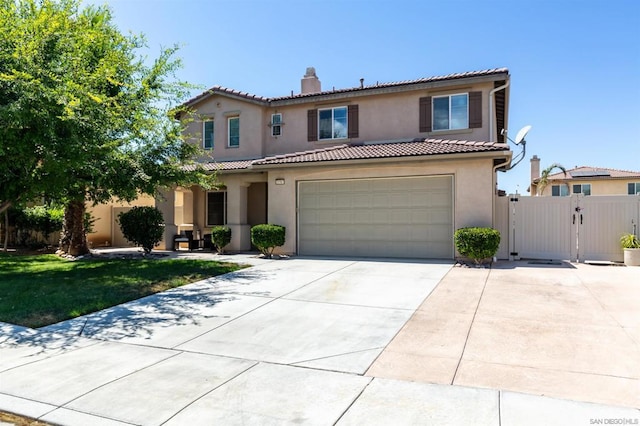 mediterranean / spanish-style house featuring a garage and a front lawn