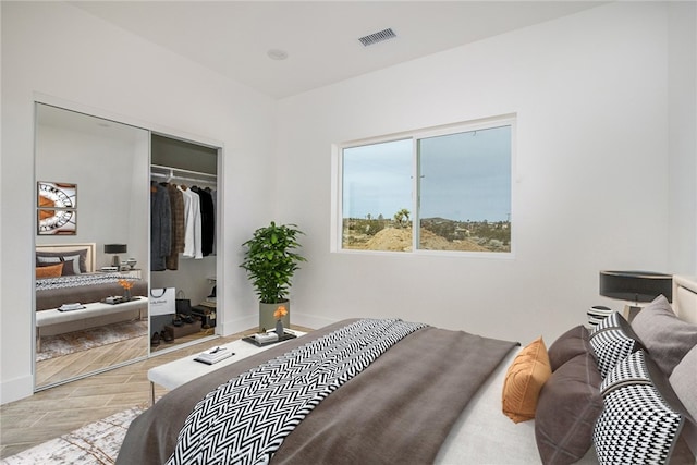 bedroom featuring light wood-type flooring and a closet