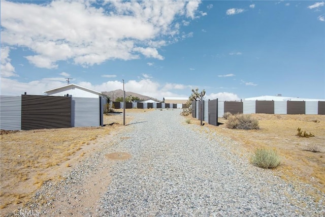 view of street with gravel driveway