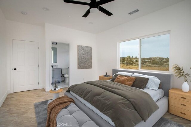 bedroom featuring connected bathroom, ceiling fan, and light hardwood / wood-style flooring