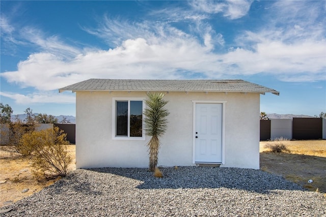 view of front of home featuring a storage shed