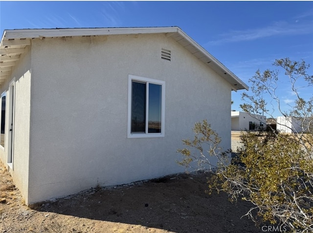 view of home's exterior with stucco siding