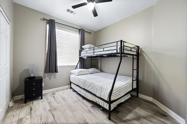 bedroom with hardwood / wood-style floors and ceiling fan